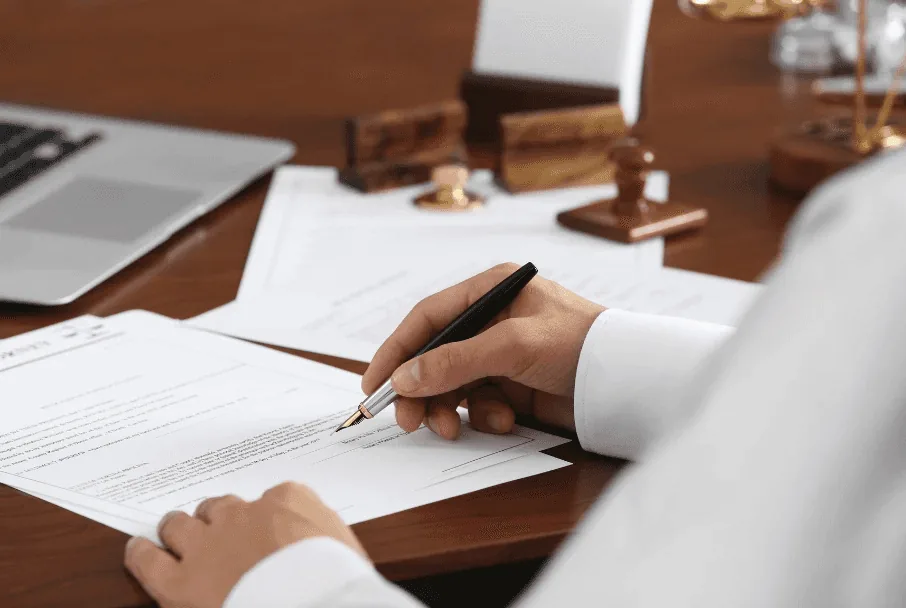Signing a contract at a desk
